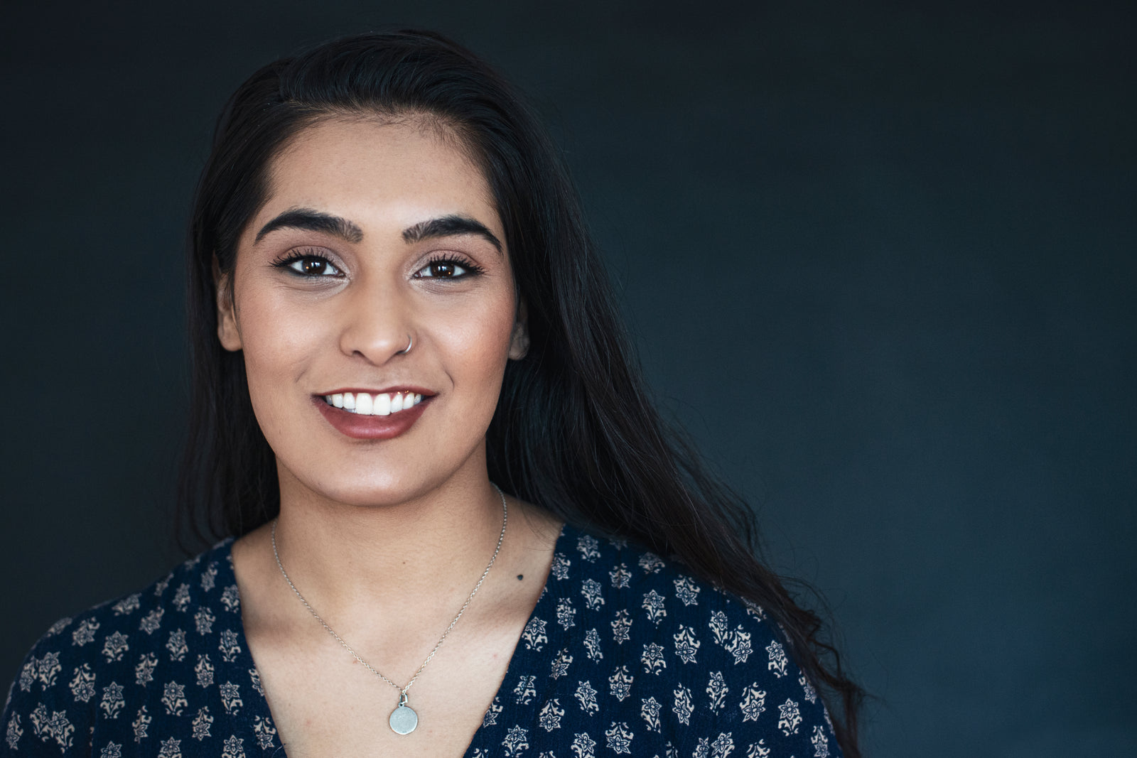 A woman smiling in a calm portrait